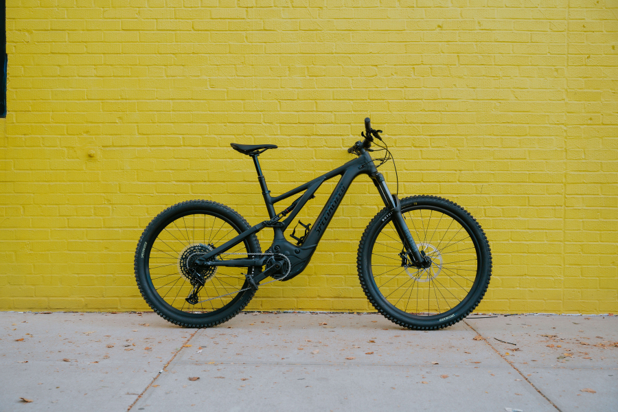 upways electric bike against a yellow wall